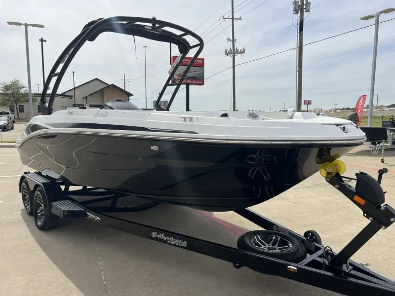 Slide: The Image of 2023 Hurricane SS205-IO 4.5 MPI boat on trailer, sleek black design, outdoor display. - 7