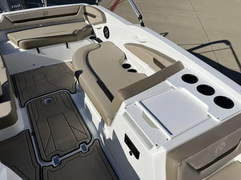 Slide: The Image of 2023 Hurricane SS205-OB boat interior with beige seating and cup holders. - 11