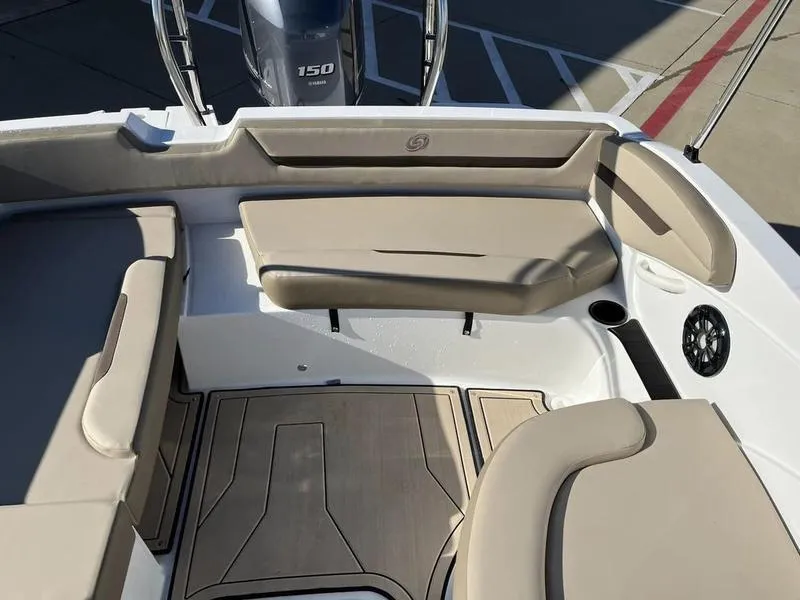 Slide: The Image of 2023 Hurricane SS205-OB boat interior with beige seating and Yamaha 150 outboard motor. - 13