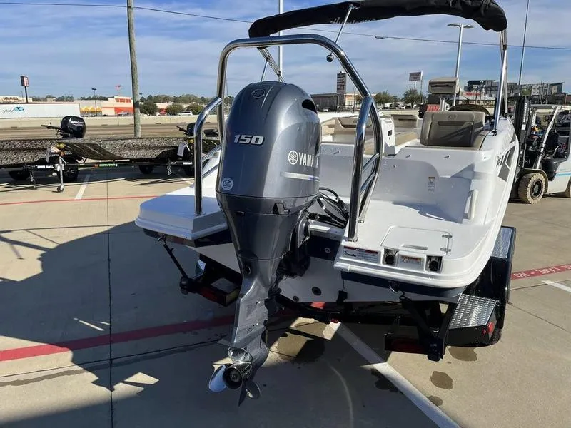 Slide: The Image of 2023 Hurricane SS205-OB boat with Yamaha 150 outboard motor in a dealership lot. - 6