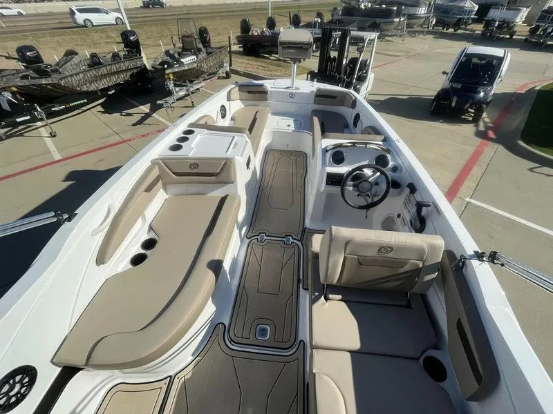 Slide: The Image of 2023 Hurricane SS205-OB boat interior with beige seating and modern dashboard. - 8