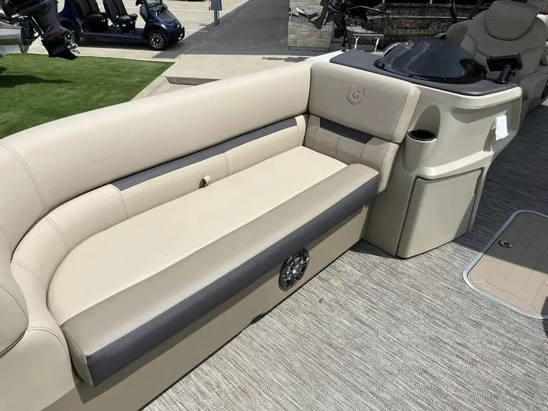 Slide: The Image of 2023 Godfrey Sweetwater 2286SB boat interior with beige seating and console. - 11