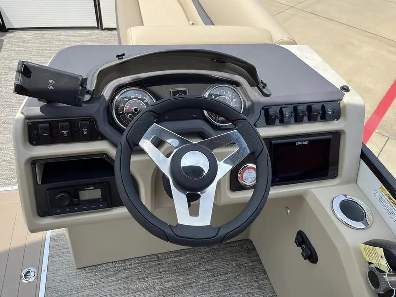 Slide: The Image of 2023 Godfrey Sweetwater 2286SB boat dashboard with steering wheel and control panel. - 17