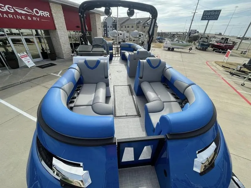 Slide: The Image of 2023 Montara Surf Boss boat with blue and gray seating at a dealership. - 14