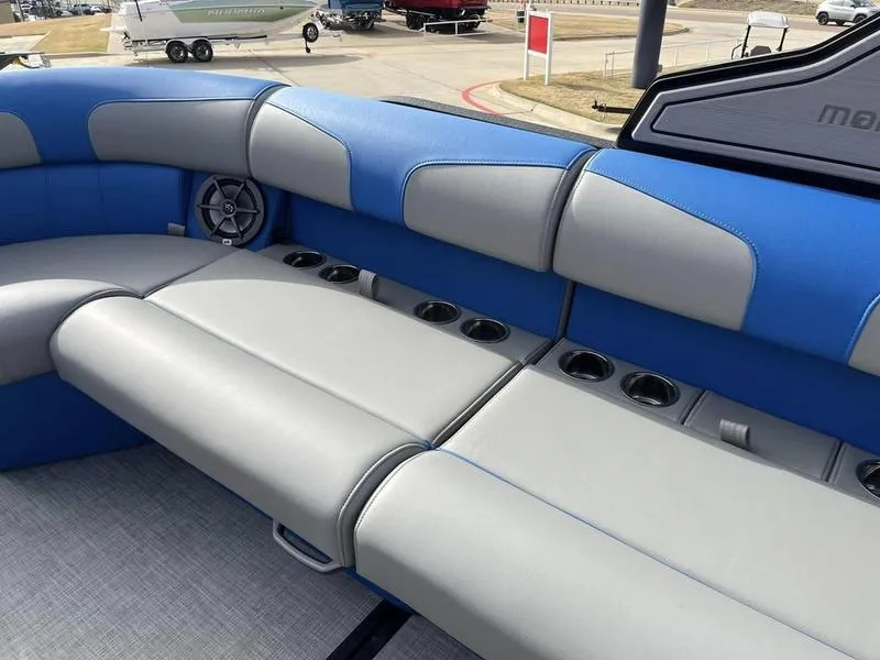 Slide: The Image of 2023 Montara Surf Boss boat interior with blue and gray seating and cup holders. - 23