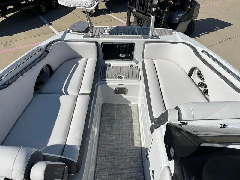 Slide: The Image of 2023 Crownline E205XS boat interior with sleek seating and modern dashboard. - 11