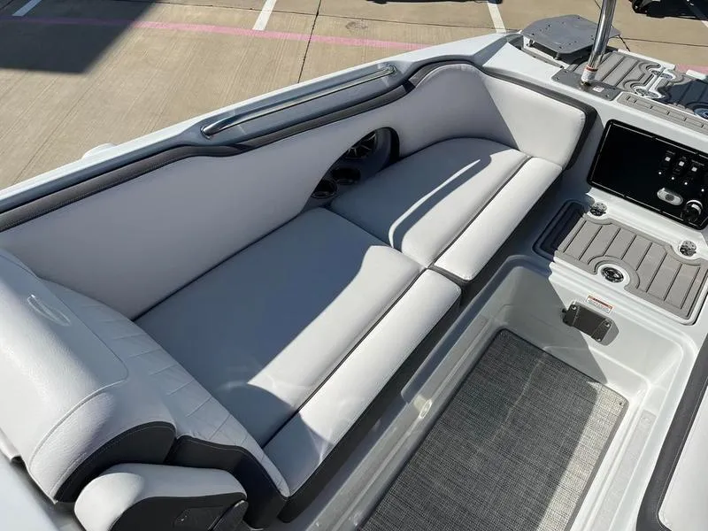 Slide: The Image of 2023 Crownline E205XS boat interior with sleek seating and modern dashboard. - 13