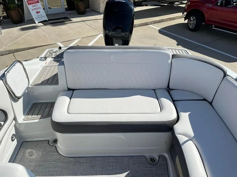 Slide: The Image of 2023 Crownline E205XS boat interior with white cushioned seating. - 18