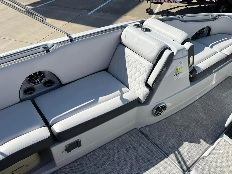 Slide: The Image of 2023 Crownline E205XS boat interior with gray seating and cup holders. - 21