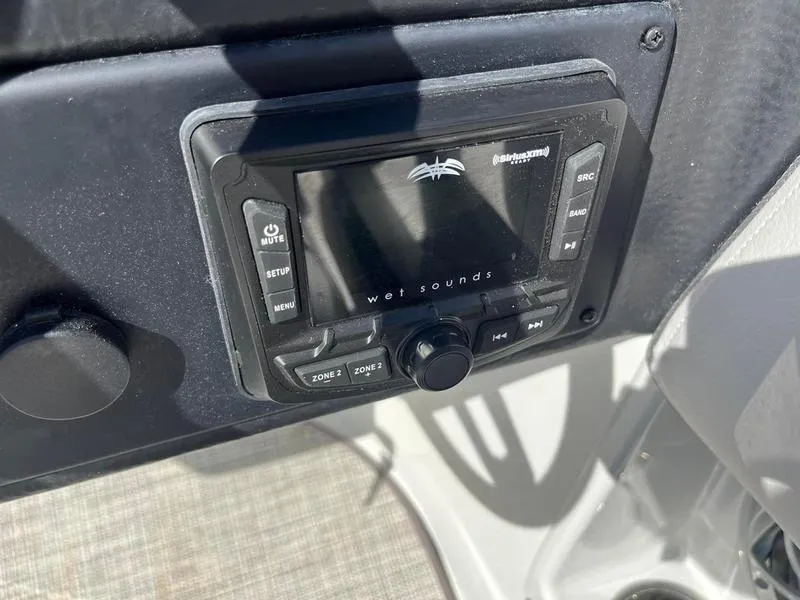 Slide: The Image of Wet Sounds audio system on 2023 Crownline E205XS boat dashboard. - 23
