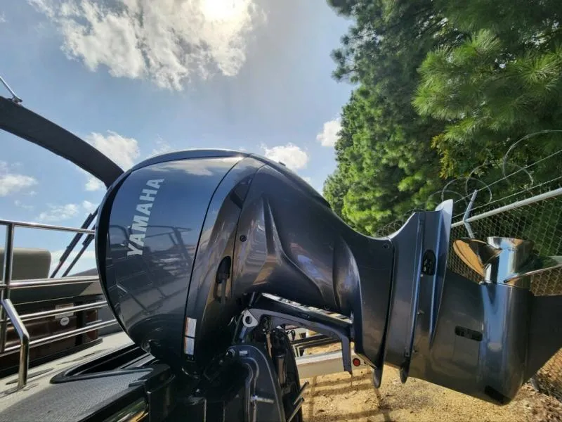 Slide: The Image of Yamaha outboard motor on 2024 Starcraft SLS-5 Q DH boat, sunny day, trees in background. - 11