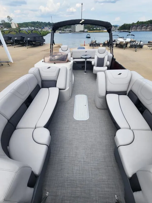 Slide: The Image of 2024 Starcraft SLS-5 Q DH pontoon boat with spacious seating at a marina. - 4