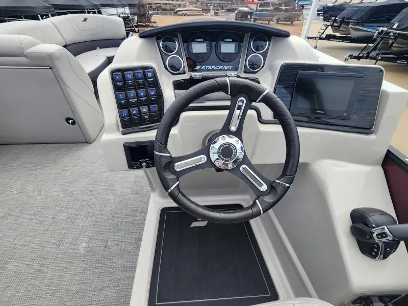 Slide: The Image of 2024 Starcraft SLS-5 Q DH boat dashboard with steering wheel and control panel. - 6