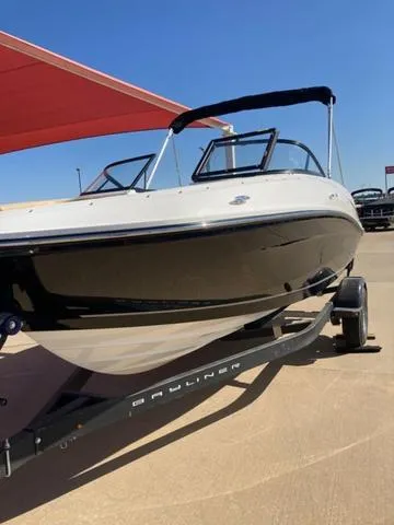 Slide: The Image of 2023 Bayliner VR5 boat on trailer under a red canopy. - 2