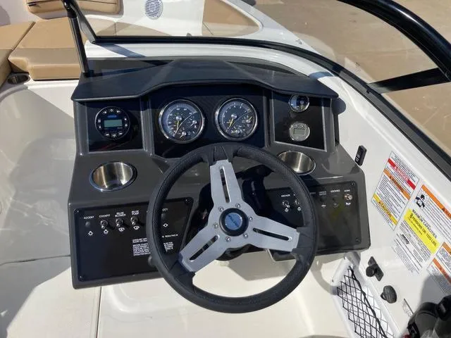 Slide: The Image of 2023 Bayliner VR5 boat dashboard with steering wheel and instrument panel. - 4