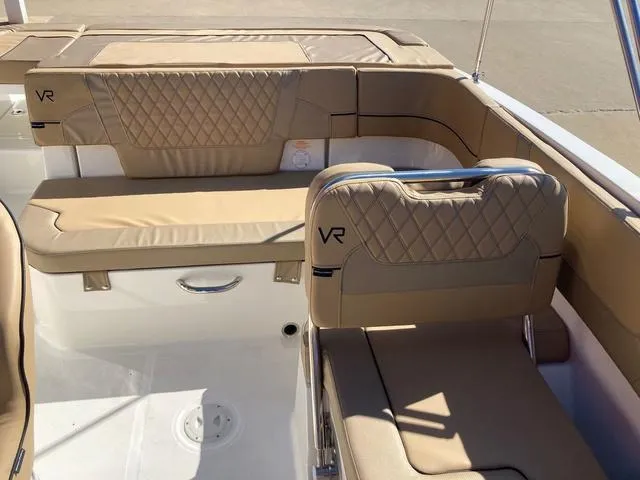 Slide: The Image of 2023 Bayliner VR5 boat interior with tan quilted seating. - 5