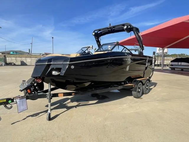 Slide: The Image of 2023 Heyday WT-2DC black boat on trailer under blue sky. - 2
