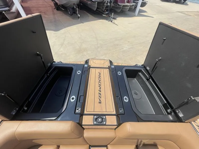 Slide: The Image of 2024 Moomba Craz boat storage compartments open, showcasing spacious interior. - 10