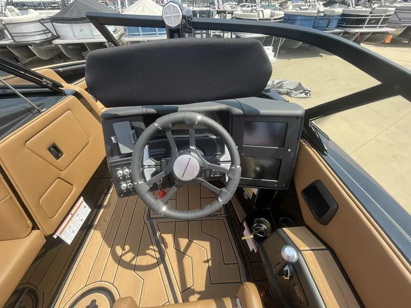 Slide: The Image of 2024 Moomba Craz boat dashboard with steering wheel and control panel. - 6