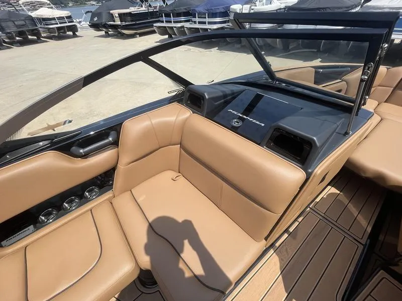 Slide: The Image of 2024 Moomba Craz boat interior with tan leather seats and modern dashboard. - 7