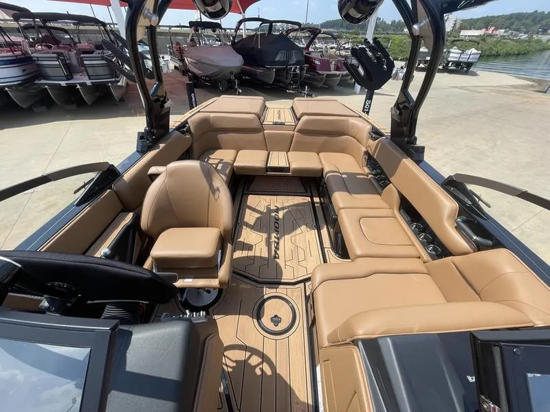 Slide: The Image of 2024 Moomba Craz boat interior with tan leather seating and wood flooring. - 9