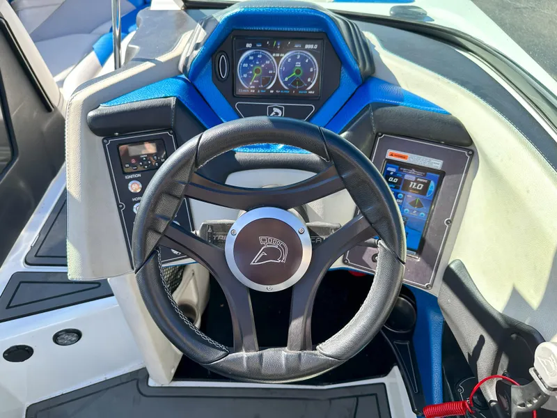Slide: The Image of 2016 Centurion FS44 boat dashboard with steering wheel and digital displays. - 12