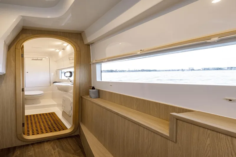 Slide: The Image of Interior of 2024 Aquila 36 Sport yacht, featuring modern bathroom and scenic window view. - 11