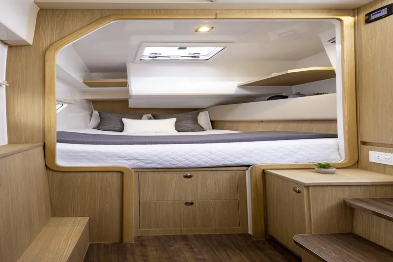 Slide: The Image of 2024 Aquila 36 Sport cabin interior with modern wood finish and cozy bedding. - 12