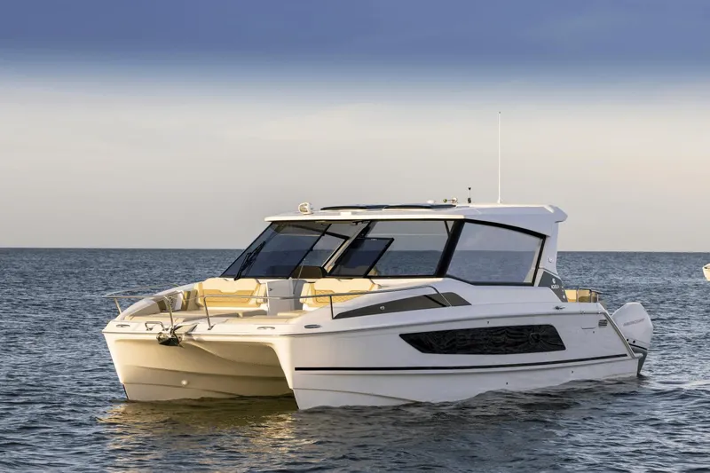 Slide: The Image of 2024 Aquila 36 Sport boat cruising on open water. - 2
