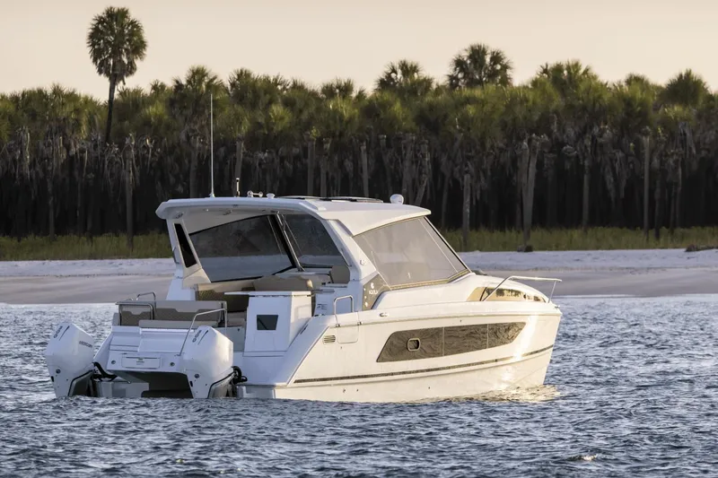 Slide: The Image of 2024 Aquila 36 Sport boat on water near tropical shoreline. - 3