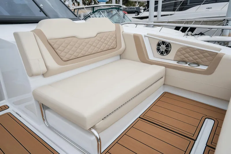 Slide: The Image of Luxurious seating on 2024 Aquila 36 Sport boat with elegant design and wood flooring. - 8