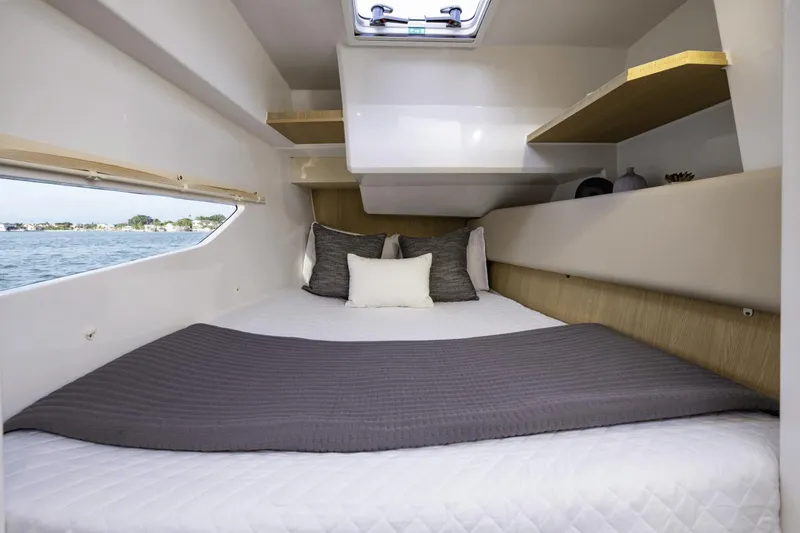 Slide: The Image of 2024 Aquila 36 Sport cabin interior with cozy bed and window view. - 9