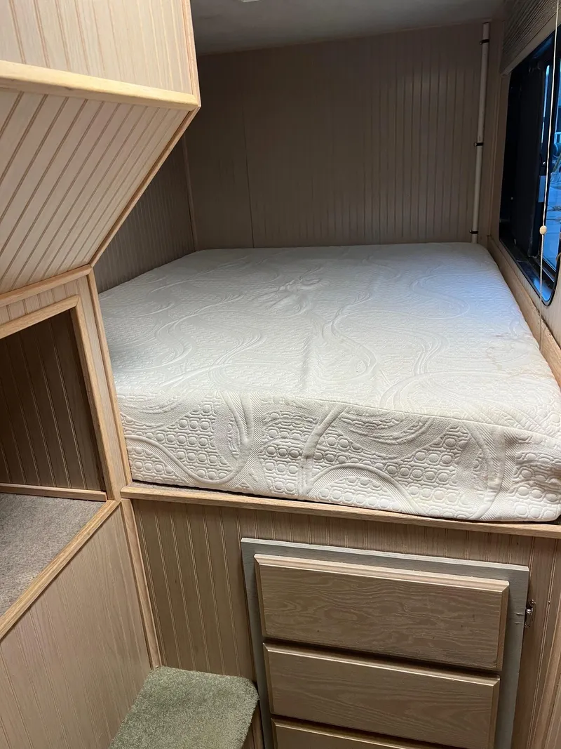 Slide: The Image of Custom 1998 Escalante Share #8 RV interior with bed and storage. - 10