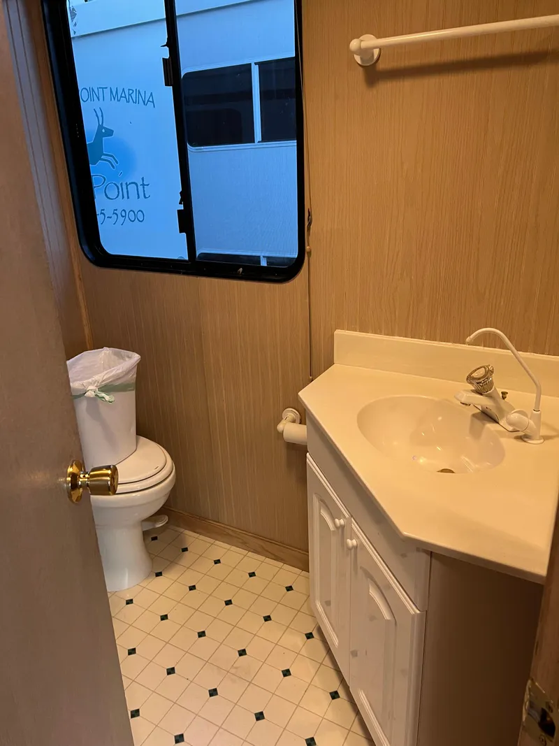 Slide: The Image of 1998 Custom Escalante Share #8 bathroom with sink, toilet, and window. - 14