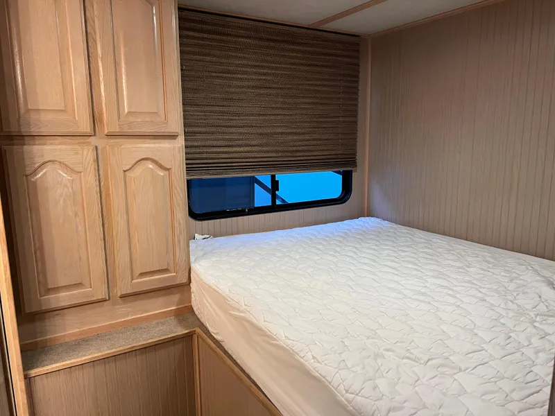 Slide: The Image of 1998 Custom Escalante Share #8 RV interior bedroom with bed and wooden cabinets - 15