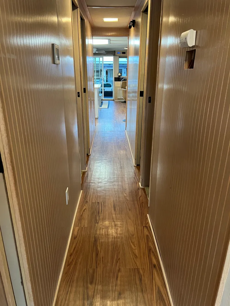 Slide: The Image of Narrow hallway with wooden flooring in a 1998 Custom Escalante share #8. - 18