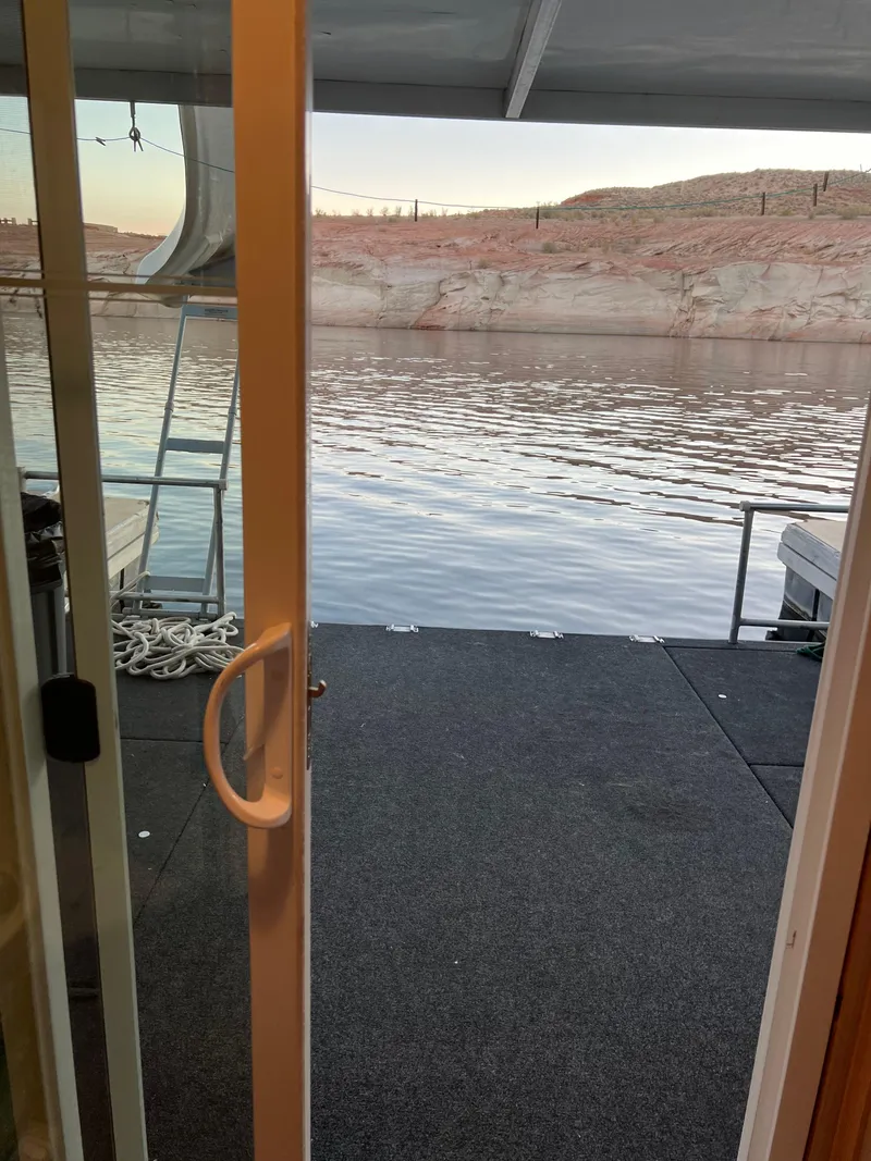 Slide: The Image of View from a 1998 Custom Escalante share #8 houseboat onto a serene lake. - 19