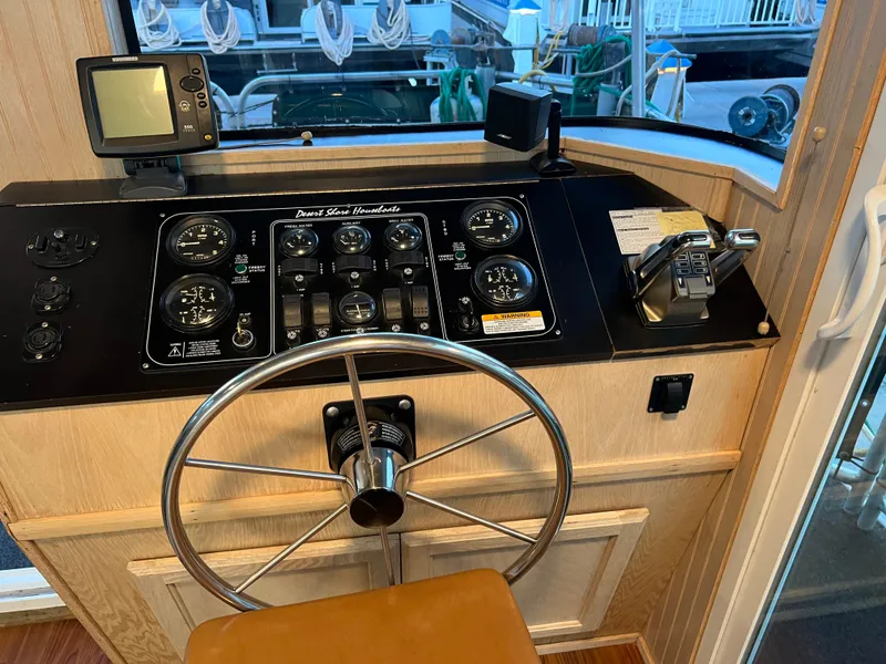 Slide: The Image of Boat control panel with steering wheel, gauges, and navigation equipment, Custom Escalante share #8, 1998. - 21