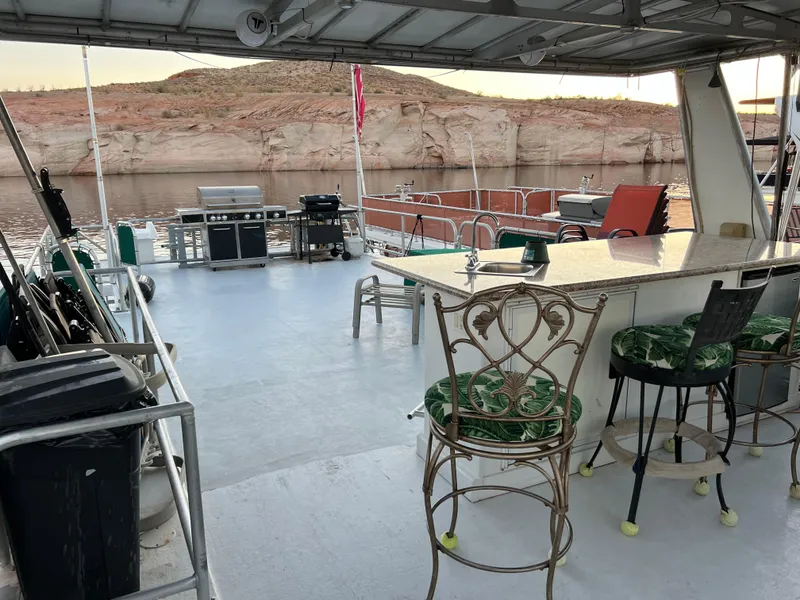 Slide: The Image of Houseboat deck with bar stools, grill, and scenic lake view. Custom Escalante share #8, 1998 model. - 22
