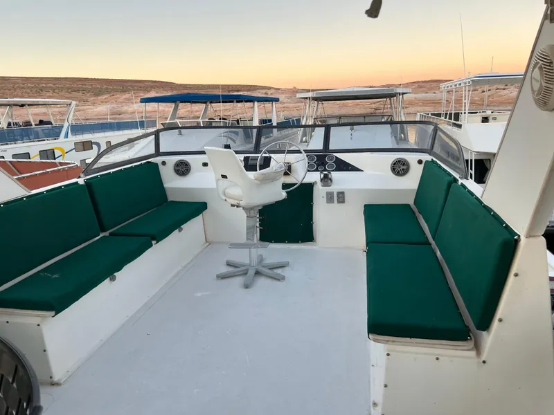 Slide: The Image of Custom 1998 Escalante share #8 boat with green cushioned seating and steering wheel. - 23