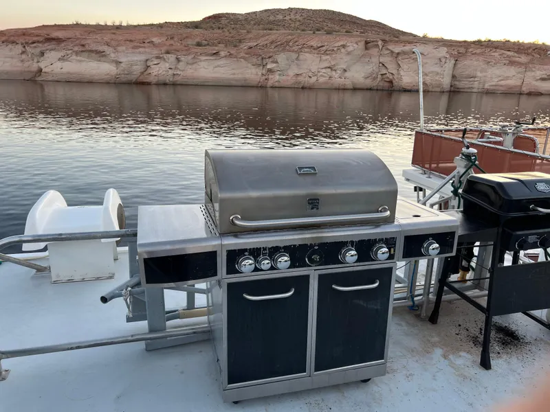 Slide: The Image of Outdoor grill on a 1998 Custom Escalante share #8 houseboat by a scenic lake. - 25