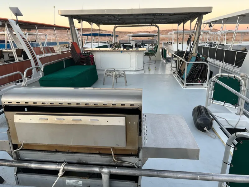 Slide: The Image of Upper deck of 1998 Custom Escalante share #8 houseboat with BBQ grill and seating area. - 27