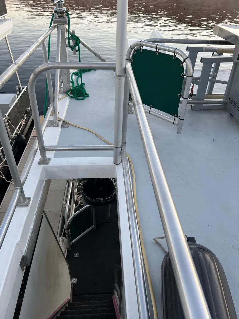 Slide: The Image of Upper deck of 1998 Custom Escalante share #8 boat with stairs leading below. - 28