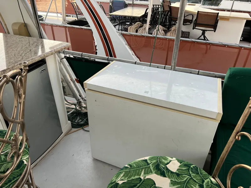 Slide: The Image of Boat interior with mini fridge, countertop, and seating, Custom Escalante share #8, 1998 model. - 29