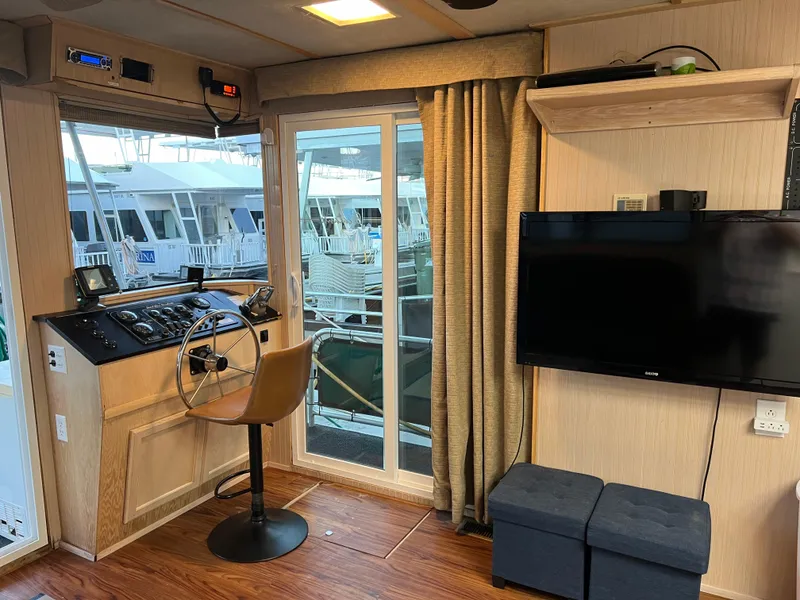 Slide: The Image of Interior of 1998 Custom Escalante share #8 houseboat with helm, TV, and marina view. - 5