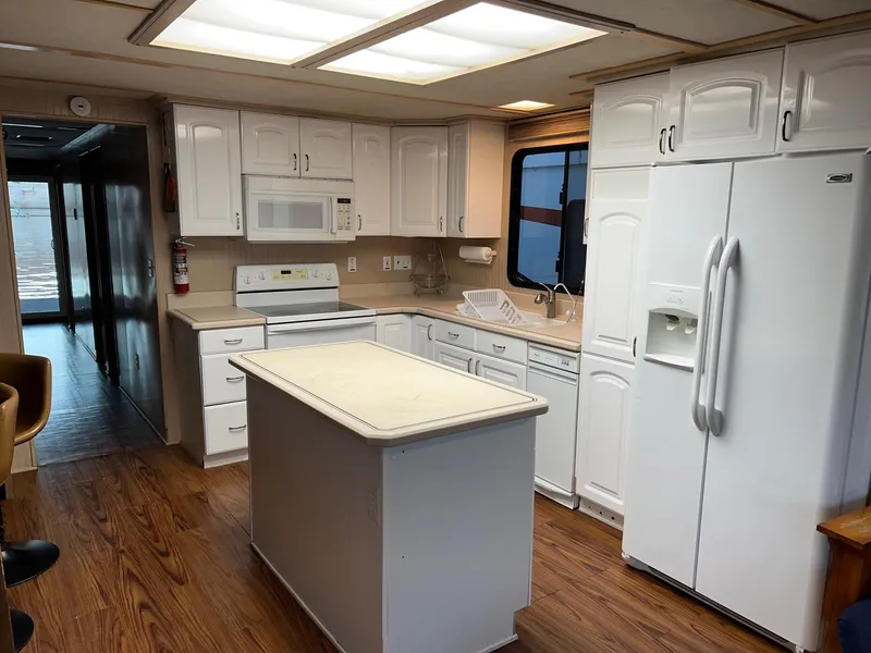 Slide: The Image of Spacious kitchen in 1998 Custom Escalante share #8 with white cabinetry and island. - 6