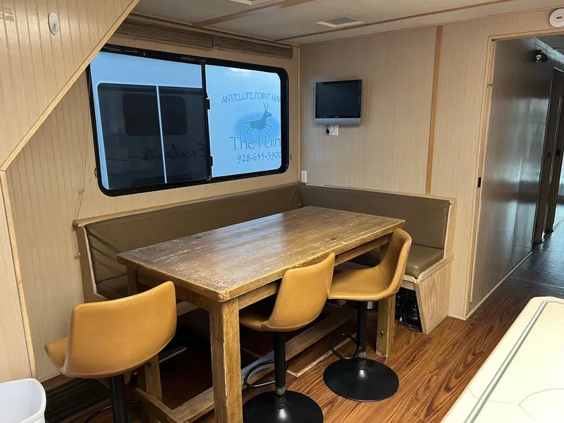 Slide: The Image of Dining area in 1998 Custom Escalante share #8 houseboat with wooden table and chairs. - 7