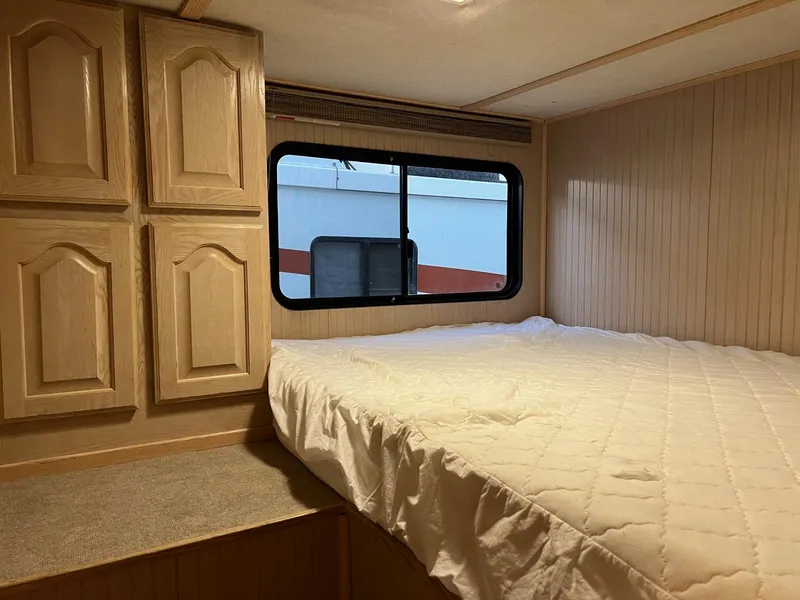 Slide: The Image of Interior of a 1998 Custom Escalante Share #8 RV with bed and storage cabinets. - 8
