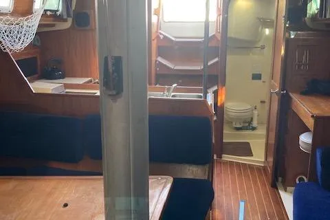 Slide: The Image of Interior of 1985 Pearson 36-2 sailboat with wooden furnishings and compact bathroom. - 10