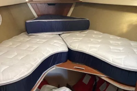 Slide: The Image of V-berth with custom mattresses in a 1985 Pearson 36-2 sailboat cabin. - 11